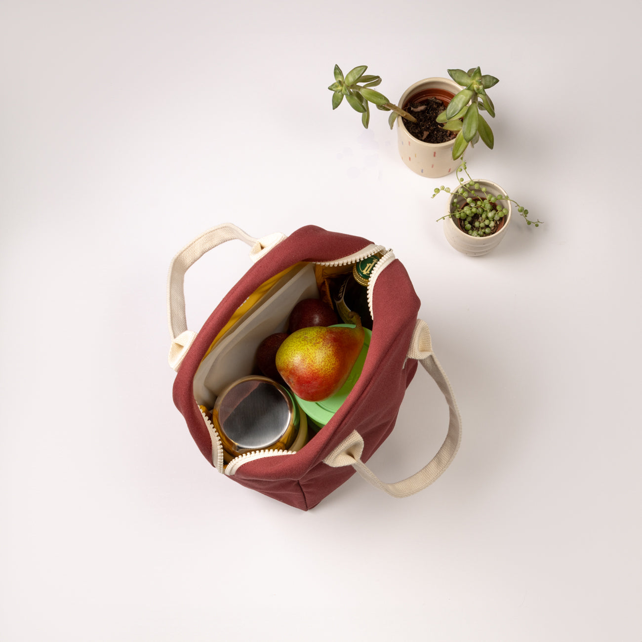 Red lunch bag with fruit and container