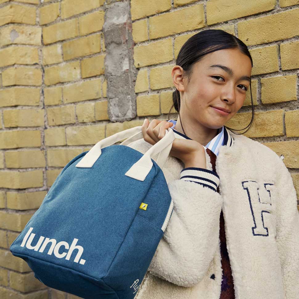 Teenager girl holding Cypress green lunch bag