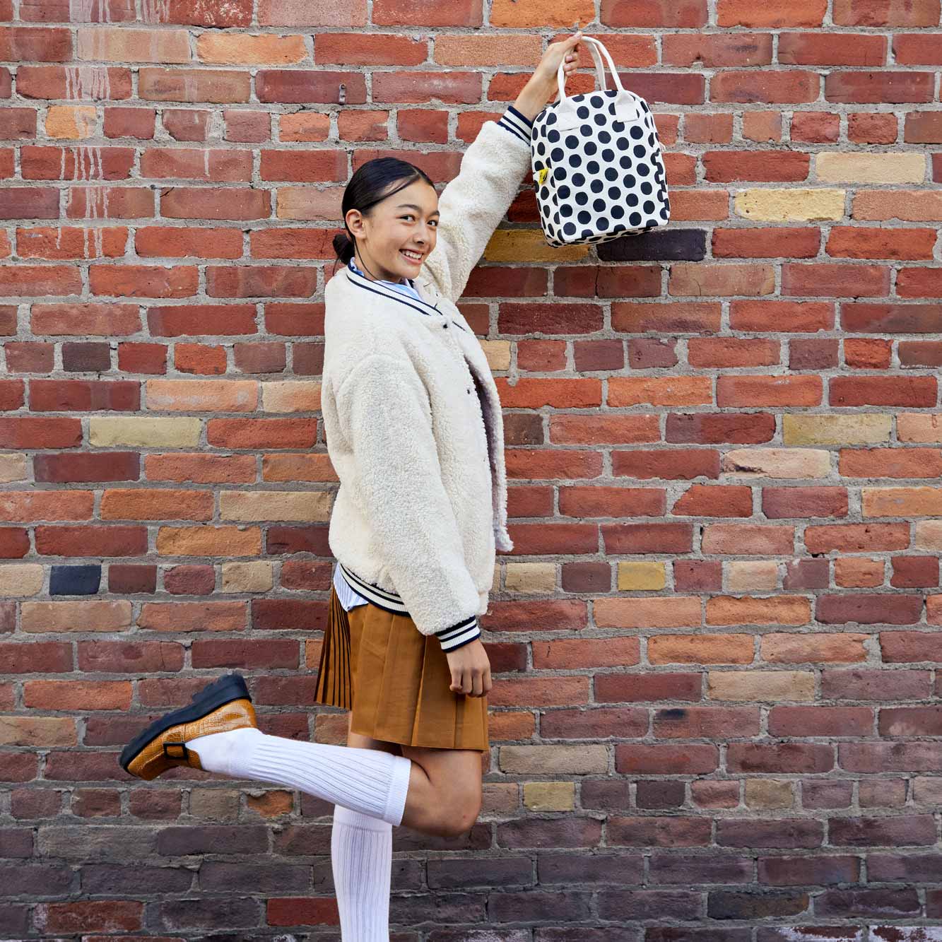 a Teenager with a black and white polka dot lunch bags by fluf