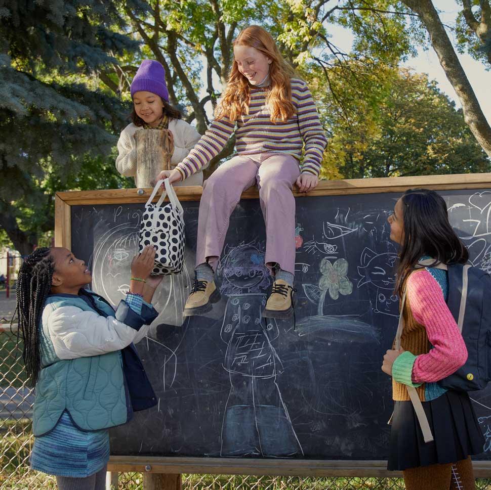 Kids playing with black and white  polka dot lunch bag by fluf