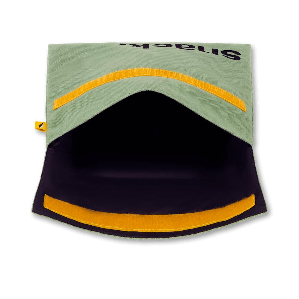 an open Reusable and machine washable green moss snack bag in a sandwich size, with black 'snack' design  and yellow velcro