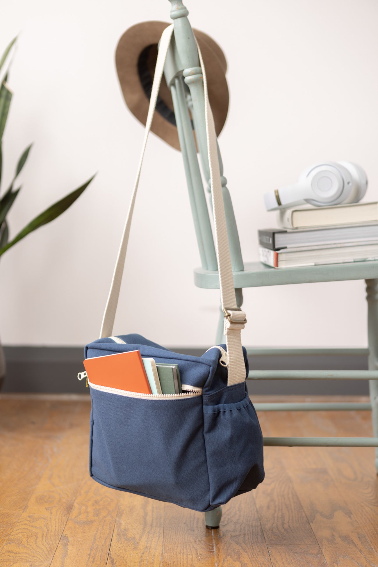 lunch bag with crossbody strap by fluf hanging on a chair