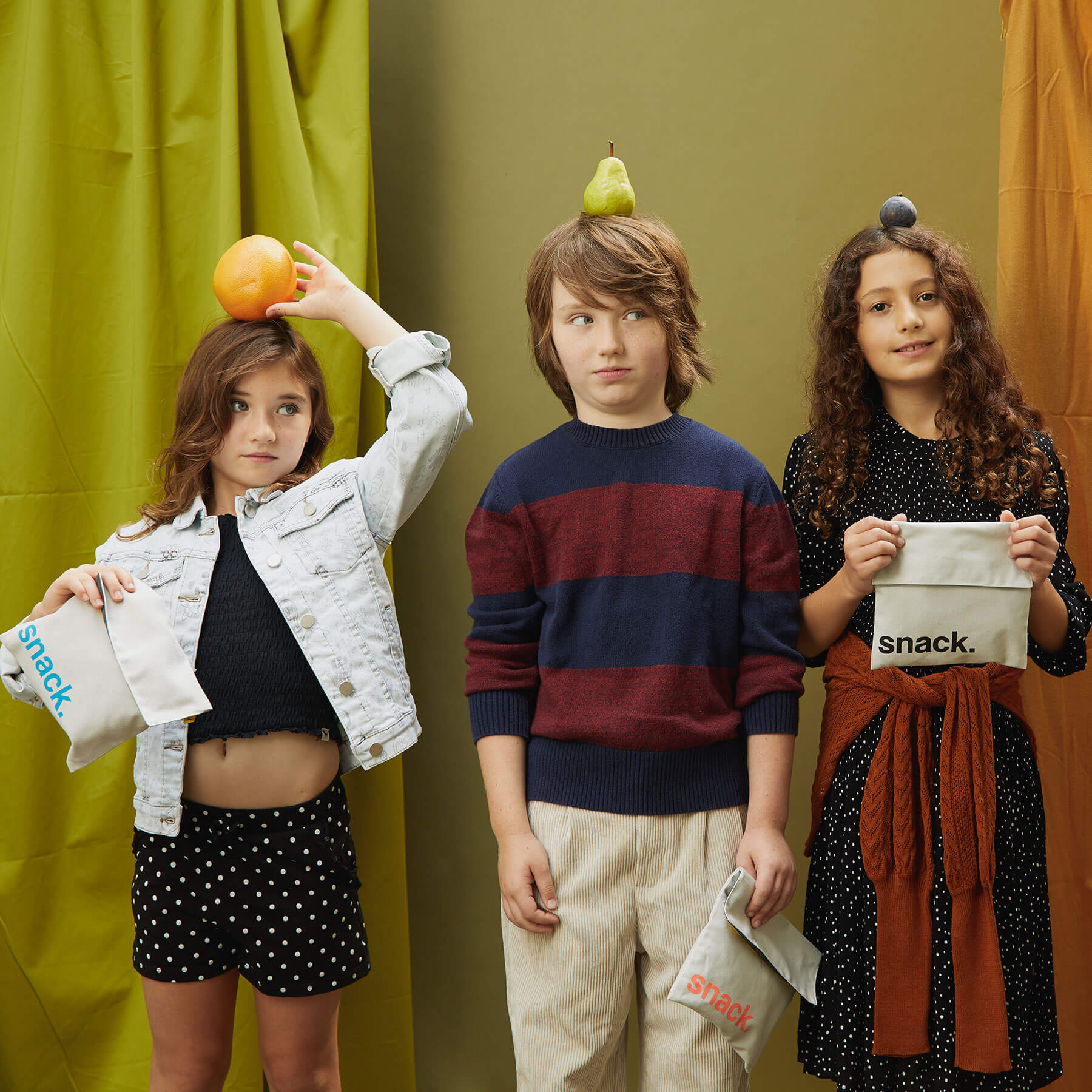 3 kids holding different 'Snack' Snack baggies for Kids, one of them is'Snack' Blue Snack Pack