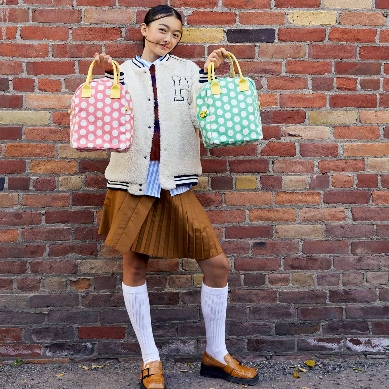 teenager holding zipper lunch bags with white polka dots